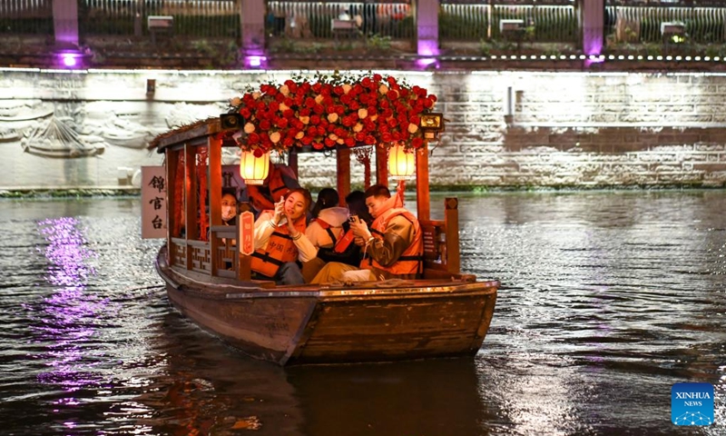 Visitors are seen on a tourist boat on the Jinjiang River in Chengdu of southwest China's Sichuan Province, on March 1, 2023. The 31st FISU Summer World University Games is scheduled to take place in Chengdu from July 28 to August 8, 2023. (Xinhua/Tang Wenhao)