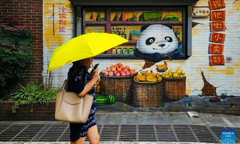 A visitor walks on a gourmet street in Chengdu of southwest China's Sichuan Province, on June 25, 2023. The 31st FISU Summer World University Games is scheduled to take place in Chengdu from July 28 to August 8, 2023. (Xinhua/Shen Bohan)