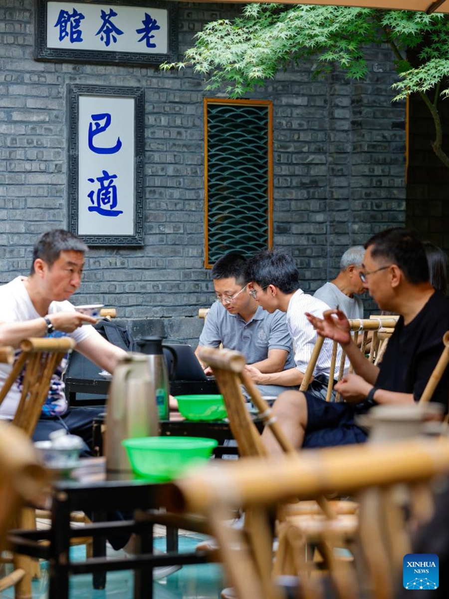 People enjoy tea at an open tea house in Chengdu of southwest China's Sichuan Province, on June 7, 2023. The 31st FISU Summer World University Games is scheduled to take place in Chengdu from July 28 to August 8, 2023. (Xinhua/Shen Bohan)