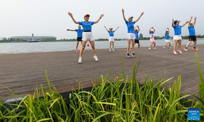 People do exercises at a park in Chengdu, capital of southwest China's Sichuan Province, July 12, 2023. The 31st International University Sports Federation (FISU) Summer World University Games will be held in Chengdu from July 28 to August 8.(Photo: Xinhua)