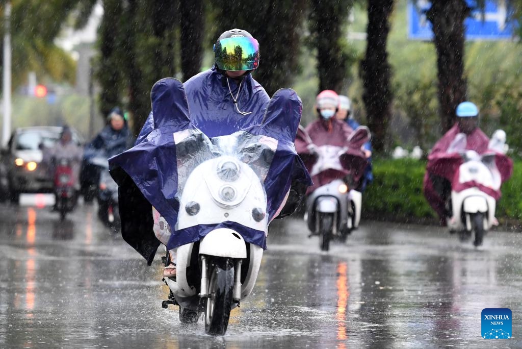 Citizens ride electric bicycles in the rain in downtown Nanning, south China's Guangxi Zhuang Autonomous Region, on July 18, 2023. Typhoon Talim, the fourth typhoon this year, landed in the coastal area of south China's Guangxi Zhuang Autonomous Region early Tuesday, the typhoon's second landfall in China after it first landed in Guangdong Province on Monday night.(Photo: Xinhua)