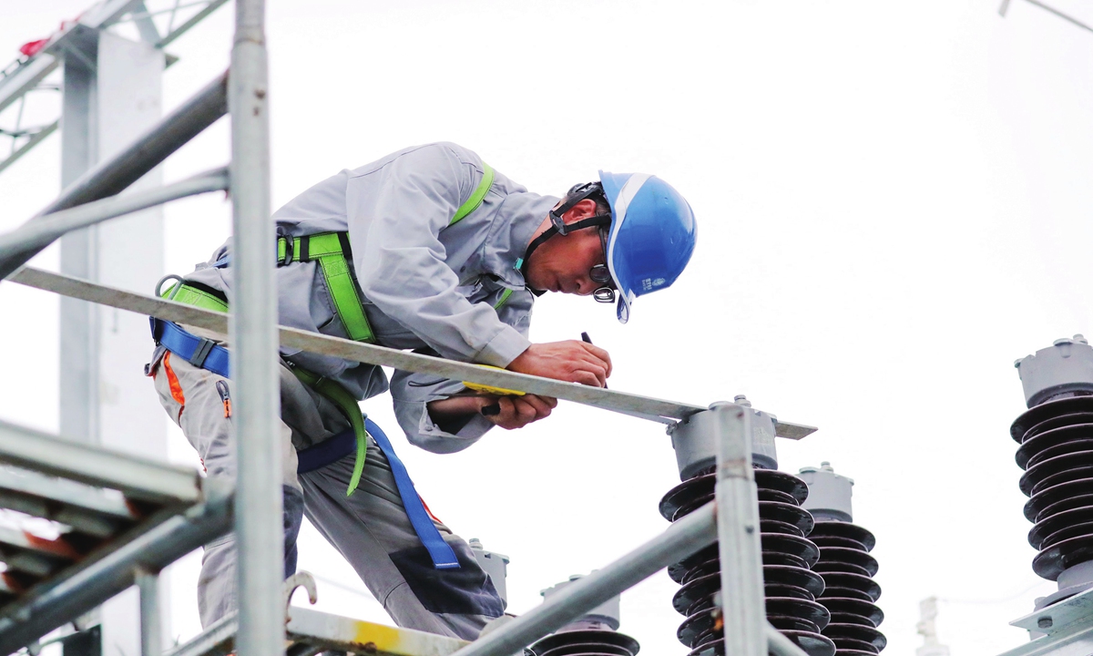 An electric power construction worker installs equipment at a local station in Bozhou, East China's Anhui Province on July 20, 2023. The 110kV intelligent substation can efficiently increase the regional power supply quality and capacity after the expected completion in August. Photo: cnsphoto