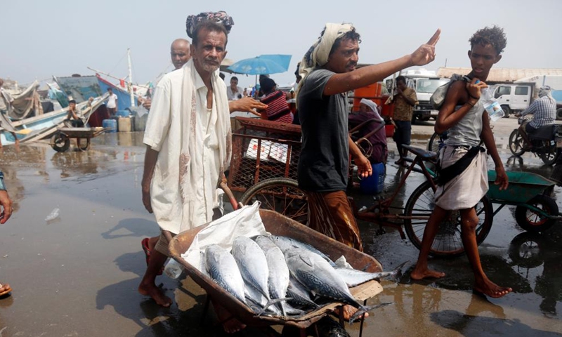 Fishermen carry freshly-caught fish to a market at a fish port in Hodeidah Province, western Yemen, on July 16, 2023.(Photo: Xinhua)