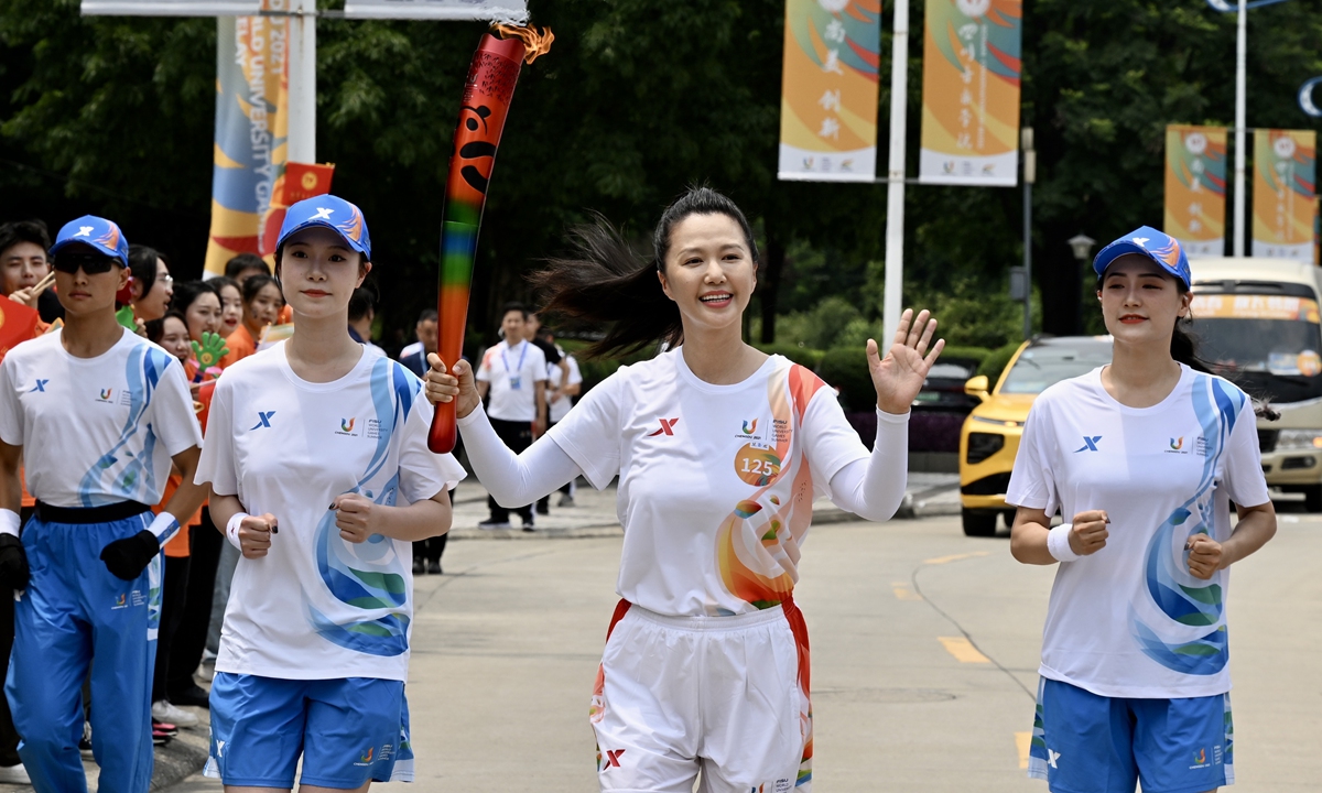 Tan Weiwei (second from right), a famous Chinese singer, takes part in the torch relay for the 31st International University Sports Federation Summer World University Games at the Sichuan Conservatory of Music in Chengdu, Southwest China's Sichuan Province, on July 20, 2023, the 4th day of the games torch relay. The games will be held from 28 July to 8 August. Photo: VCG