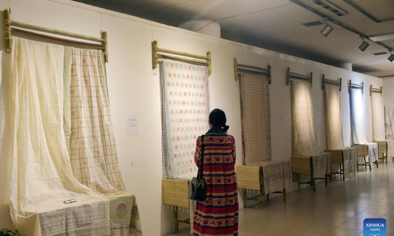 A visitor looks at Jamdani sarees (women's garment) during a festival in Dhaka, Bangladesh on July 29, 2023. In an attempt to restore the glorious past of Jamdani, Bangladesh has organized an 11-day festival titled Wearable Art Jamdani Festival in capital Dhaka from July 19 to highlight the textile here. (Xinhua)