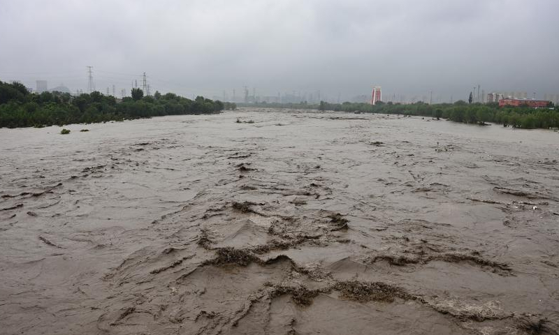 The water level of the Mentougou section of the Yongding River rises due to persistent rainfall in recent days in Mentougou district of Beijing, July 31, 2023. (Photo: China News Service/Tian Yuhao) Beijing maintained red alert, the highest level alert, for heavy rainfall on Monday.