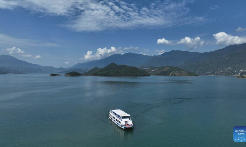 This aerial photo taken on July 26, 2023 shows visitors taking a boat at the Dongjiang Lake scenic spot in Zixing City, central China's Hunan Province. (Xinhua/Zhao Zhongzhi)