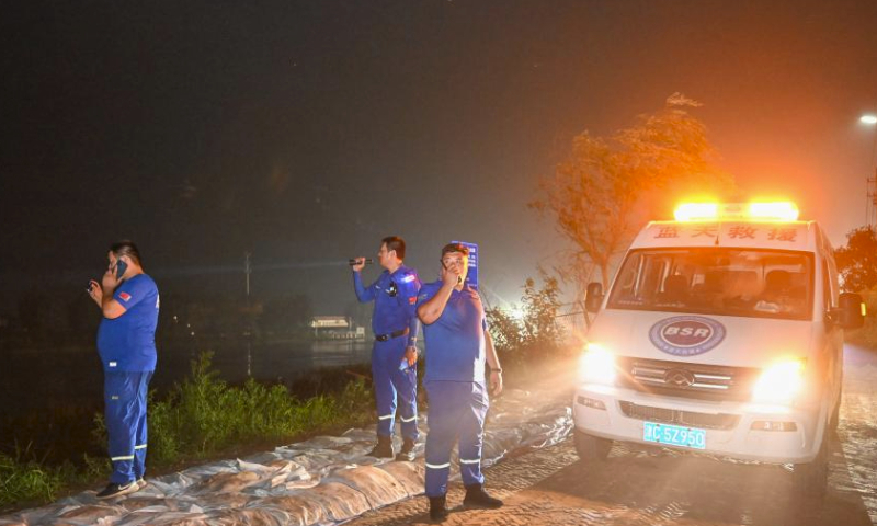 Members of the Blue Sky Rescue Team's Tianjin Jinghai branch and dam patrollers address potential safety hazards on a dam along the Daqing River in Taitou Town of Jinghai District, north China's Tianjin Municipality, Aug. 4, 2023. All residents of 18 villages under the administration of the Taitou Town have been evacuated to safety before noon of Aug. 3. All the town's flood rescue teams including members of the armed police force in Tianjin, the Blue Sky Rescue Team, local officials and rescue workers are standing by to brace for flooding from upstream river which is expected to arrive here on Aug. 4. (Xinhua/Sun Fanyue)