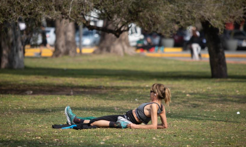 A woman sunbathes at a park during winter time in Buenos Aires, Argentina, Aug. 6, 2023. (Photo by Martin Sabala/Xinhua)