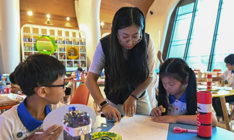 Students take part in a drawing activity at the National Maritime Museum of China in Tianjin, north China, July 29, 2023. During the summer vacation, the National Maritime Museum of China and the Tianjin Digital Art Museum jointly offered students with a study camp themed on ocean and art. Altogether 22 students from Beijing, Tianjin and Hebei Province learnt knowledge of ocean and nature and got in touch with digital art during the camp. (Xinhua/Sun Fanyue)