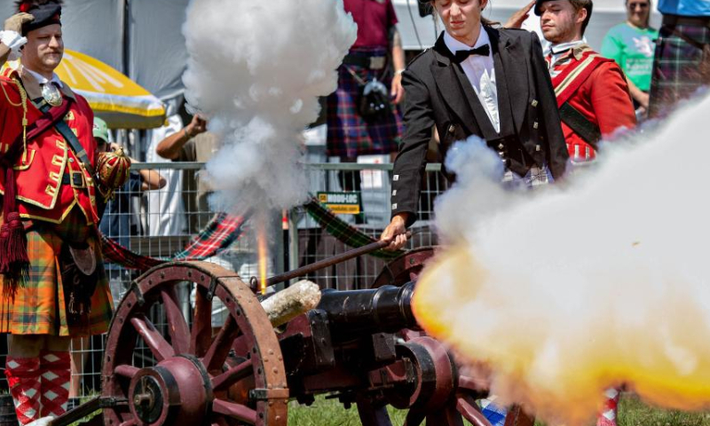 People fire a traditional cannon during the 2023 Montreal Highland Games in Montreal, Canada, on Aug. 6, 2023. The 2023 Montreal Highland Games were held here Sunday. The games, held annually during summers since 1855, feature traditional Scottish events that include pipe bands, athletes and Highland dancers. (Photo by Andrew Soong/Xinhua)