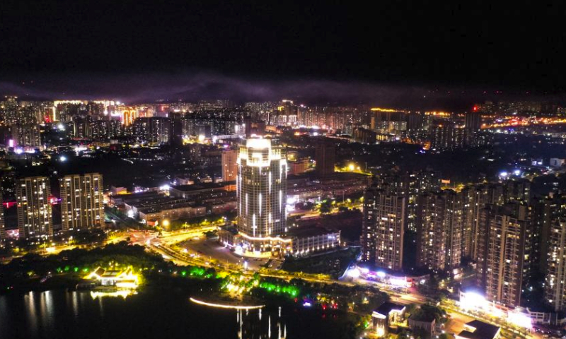 This aerial photo taken on July 21, 2023 shows a night view of Qinzhou, south China's Guangxi Zhuang Autonomous Region. Qinzhou is a node of the New International Land-Sea Trade Corridor connecting Guangxi and ASEAN countries, and its location is highly beneficial, granting the city an important role in international land-sea transport connectivity. (Xinhua/Cao Yiming)