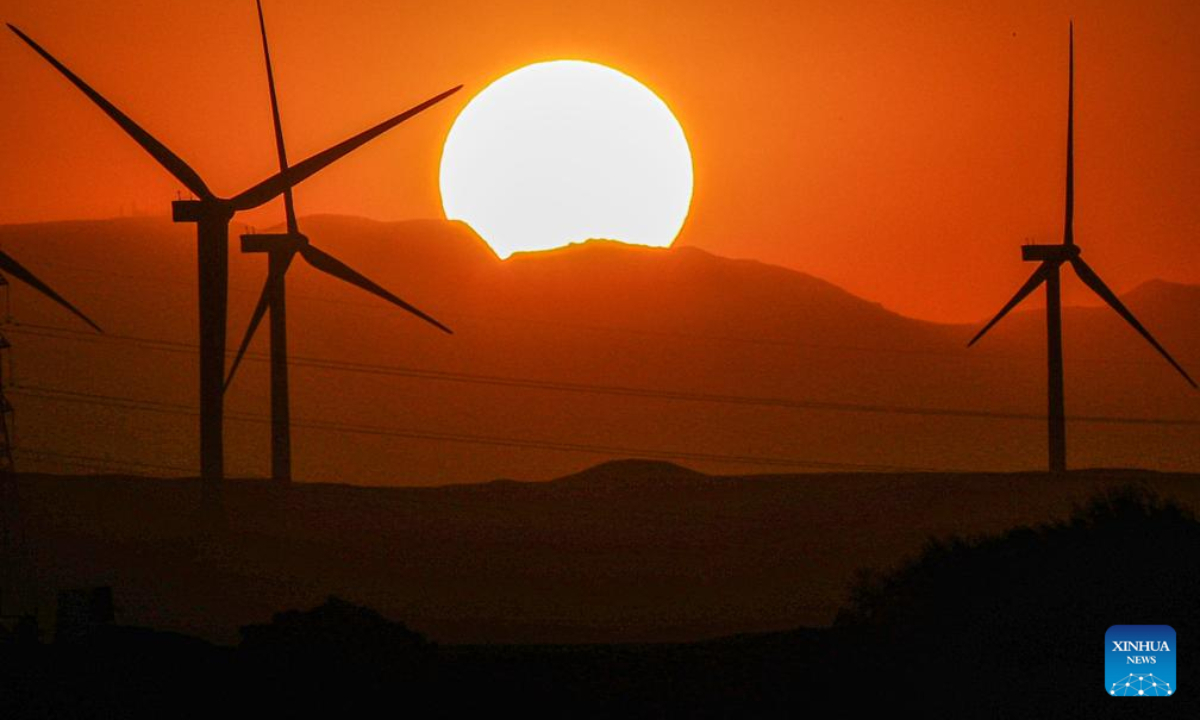 Wind turbines are silhouetted against the sunset in Hurghada, Egypt, on Aug 4, 2023. Photo:Xinhua