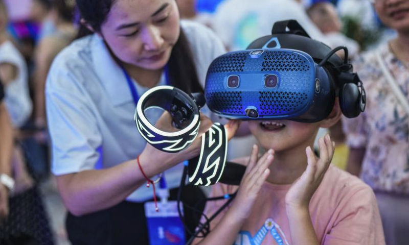 A child tries out a VR device during the first Guizhou Science and Technology Festival in Guiyang, southwest China's Guizhou Province, Aug. 5, 2023. The first Guizhou Science and Technology Festival kicked off at Guiyang International Conference and Exhibition Center on Saturday and will last till Aug. 9. (Xinhua/Tao Liang)