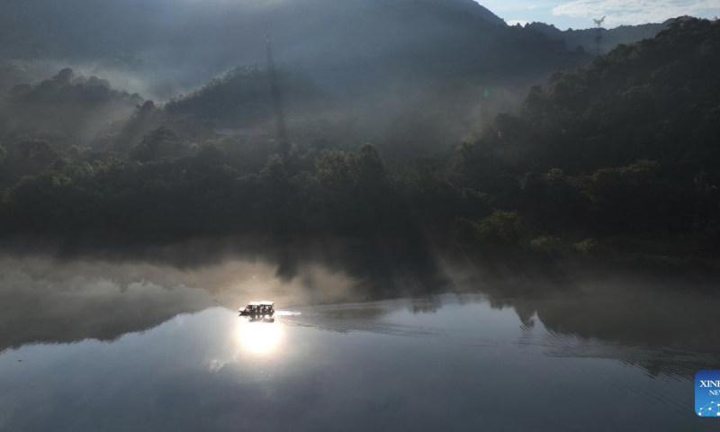 This aerial photo taken on July 26, 2023 shows visitors taking a boat at the Dongjiang Lake scenic spot in Zixing City, central China's Hunan Province. (Xinhua/Zhao Zhongzhi)