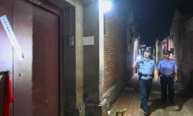 Policemen patrol in a village in Taitou Town of Jinghai District, north China's Tianjin Municipality, Aug. 4, 2023. All residents of 18 villages under the administration of the Taitou Town have been evacuated to safety before noon of Aug. 3. All the town's flood rescue teams including members of the armed police force in Tianjin, the Blue Sky Rescue Team, local officials and rescue workers are standing by to brace for flooding from upstream river which is expected to arrive here on Aug. 4. (Xinhua/Sun Fanyue)