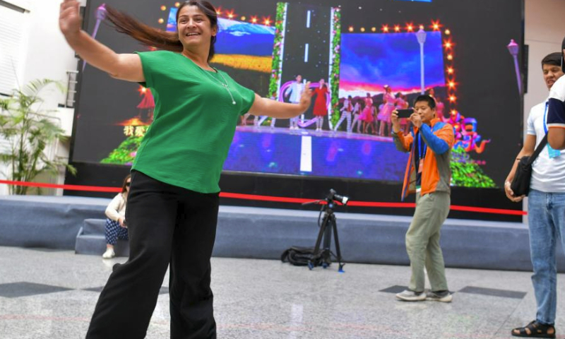 An actor of the State Honored Dance Ensemble of Tajikistan dance with music in Xinjiang Art Theater, Urumqi, northwest China's Xinjiang Uygur Autonomous Region, July 31, 2023. A communication activity featuring music and dance was held between actors of the State Honored Dance Ensemble of Tajikistan and actors of Xinjiang Art Theater on Monday. (Xinhua/Wang Fei)