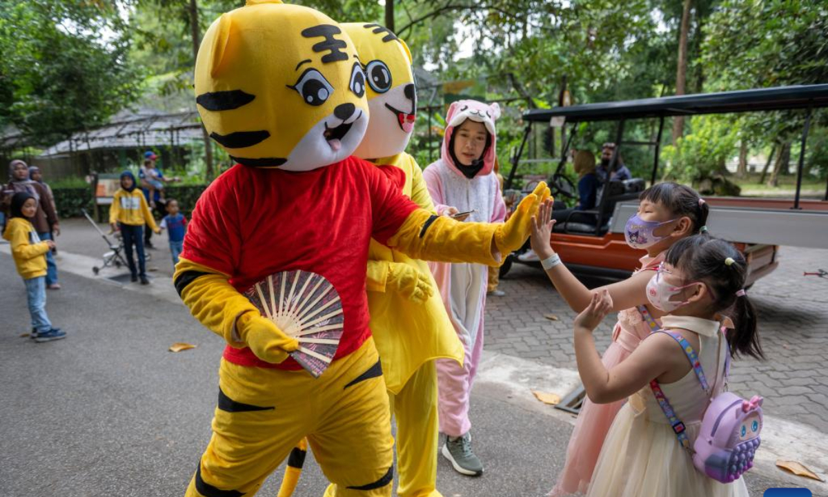 Performers in tiger-figured costumes interact with visitors at Zoo Negara, the national zoo of Malaysia, in Kuala Lumpur, Malaysia, on July 29, 2023. The International Tiger Day is marked on July 29 every year. Photo:Xinhua