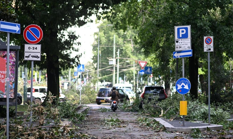 Fallen branches are seen after thunderstorms in Milan, Italy, on July 25, 2023. While the southern two-thirds of Italy struggled under the oppressive heat, most of the northern area was pelted by thunderstorms and over-sized hail. Media reports said the emergency services in Milan had responded to more than 200 requests for help related to flooding, fallen trees, and damage to cars and homes, since a severe storm hit the city late Monday. (Str/Xinhua)