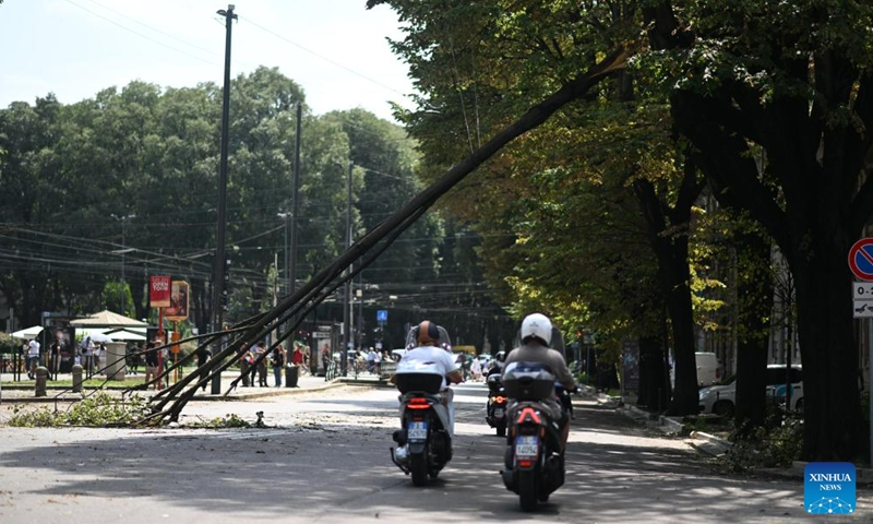 A broken branch is seen after thunderstorms in Milan, Italy, on July 25, 2023. While the southern two-thirds of Italy struggled under the oppressive heat, most of the northern area was pelted by thunderstorms and over-sized hail. Media reports said the emergency services in Milan had responded to more than 200 requests for help related to flooding, fallen trees, and damage to cars and homes, since a severe storm hit the city late Monday. (Str/Xinhua)