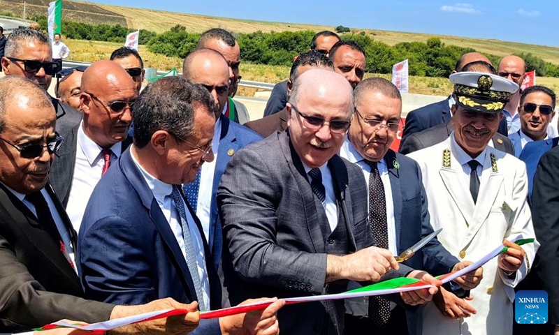 Algerian Prime Minister Ayman Benabderrahmane cuts the ribbon during the inauguration ceremony of the 84-km project of Algerian East-West Highway in El Tarf Province, Algeria, on Aug. 12, 2023. A landmark Algerian highway built to connect 17 provinces has been completed with China's CITIC Construction delivering its final 84-km segment on Saturday. (CITIC Construction Algeria/Handout via Xinhua)