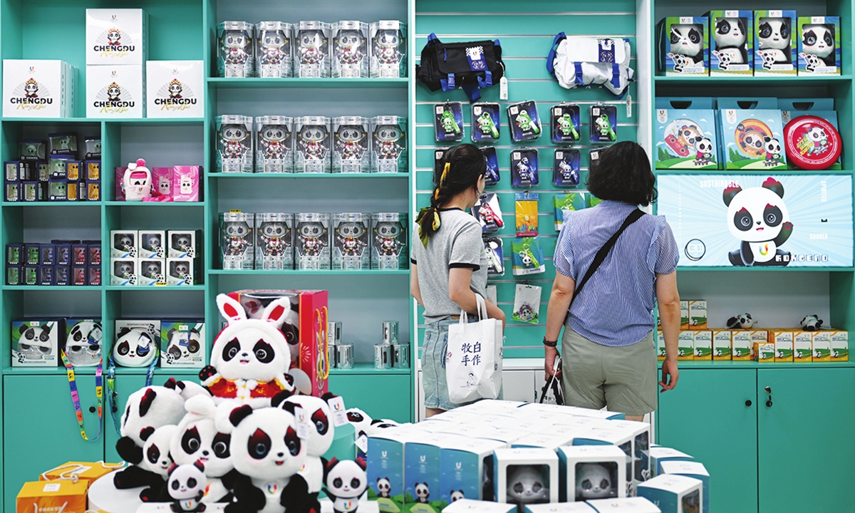 People browse products for the Chengdu University Games at a merchandise store in Chengdu on July 18. Photo: Xinhua