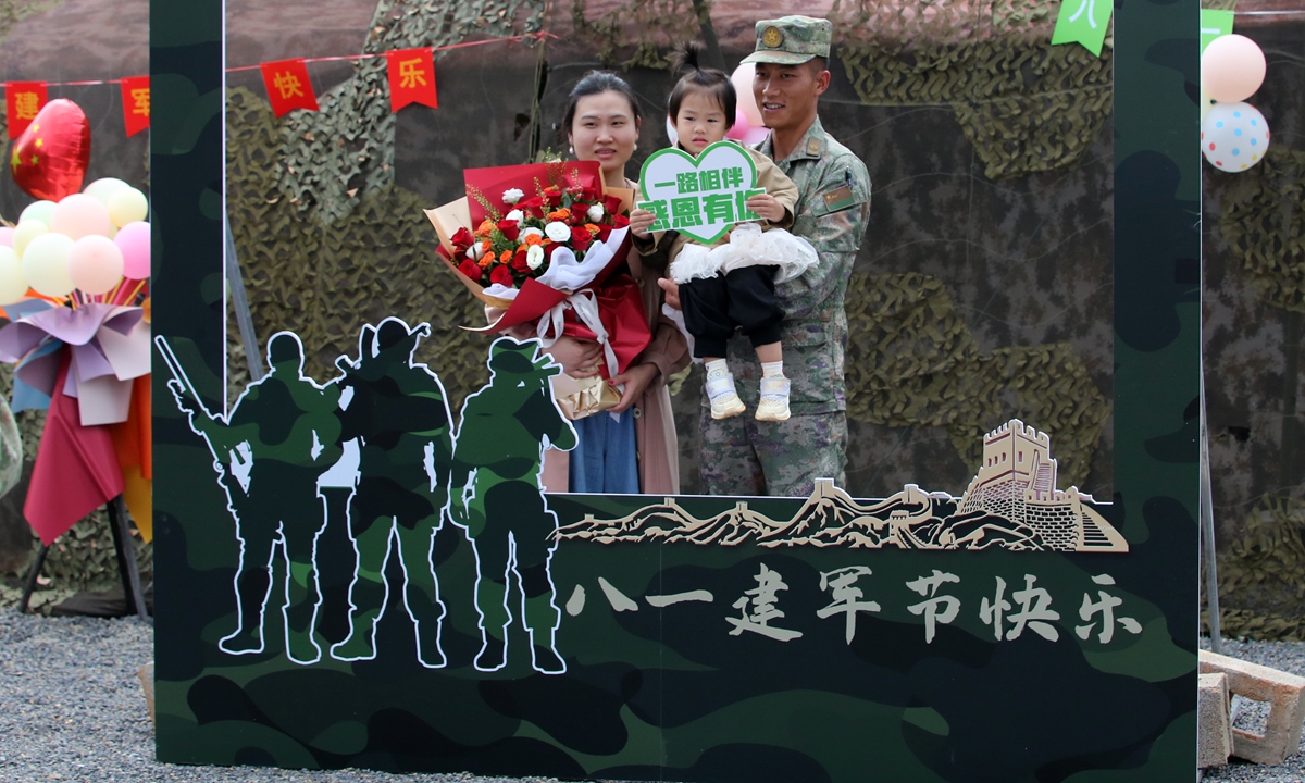 A soldier poses for a photo with his family to celebrate the 96th anniversary of the founding of the Chinese People's Liberation Army (PLA) in Qujing, Southwest China's Yunnan Province on July 30, 2023. Photo: VCG