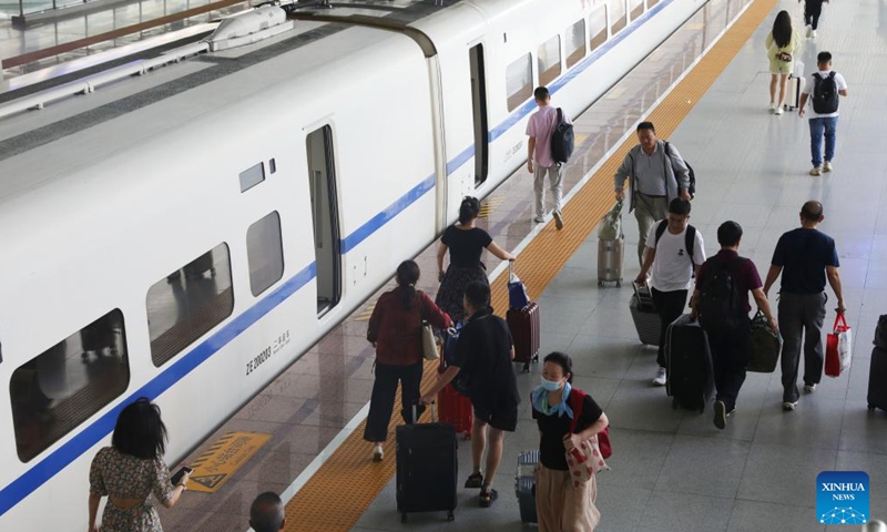 Passengers get on and off a train at Xuzhou East Railway Station in Xuzhou, east China's Jiangsu Province, Aug. 1, 2023. China's railways recorded 406 million passenger trips from July 1 to 31, according to data revealed on Tuesday by China State Railway Group Co., Ltd., the country's railway operator. During this period, daily passenger trips averaged 13.1 million, while 10,169 trains were operating daily, up 14.2 percent compared to the same period in 2019, according to the company.(Photo: Xinhua)