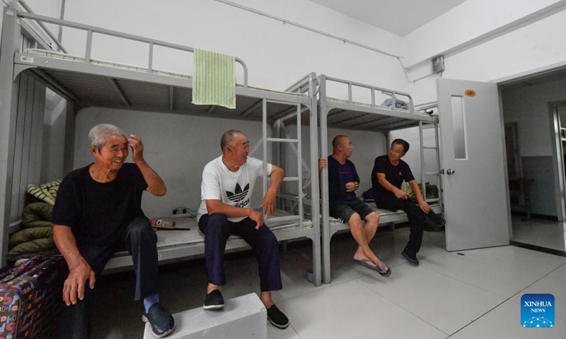 Evacuated residents chat at a temporary shelter in Wuqing District of Tianjin Municipality, Aug. 1, 2023. North China's Tianjin Municipality said Tuesday it had relocated more than 35,000 people from areas prone to flooding by the Yongding River, which has swollen amid intense rainfall. The city, which neighbors Beijing, on Tuesday upgraded its emergency response for flood from Level III to Level I, the highest level, said Tianjin's flood control and drought relief headquarters.(Photo: Xinhua)