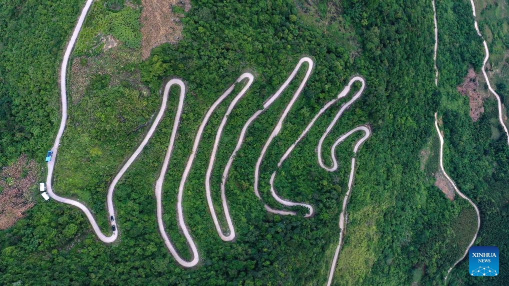 This aerial photo taken on July 31, 2023 shows a winding mountain road in Napo County, south China's Guangxi Zhuang Autonomous Region. Napo County belongs to the mountainous areas of Guangxi. In recent years, several winding mountain roads have been built to make it more convenient for local villagers to travel and to promote local economic growth at the same time.(Photo: Xinhua)