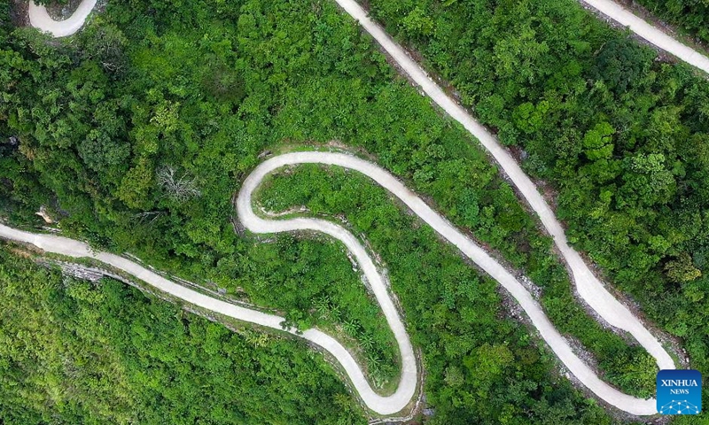 This aerial photo taken on July 31, 2023 shows a winding mountain road in Napo County, south China's Guangxi Zhuang Autonomous Region. Napo County belongs to the mountainous areas of Guangxi. In recent years, several winding mountain roads have been built to make it more convenient for local villagers to travel and to promote local economic growth at the same time.(Photo: Xinhua)