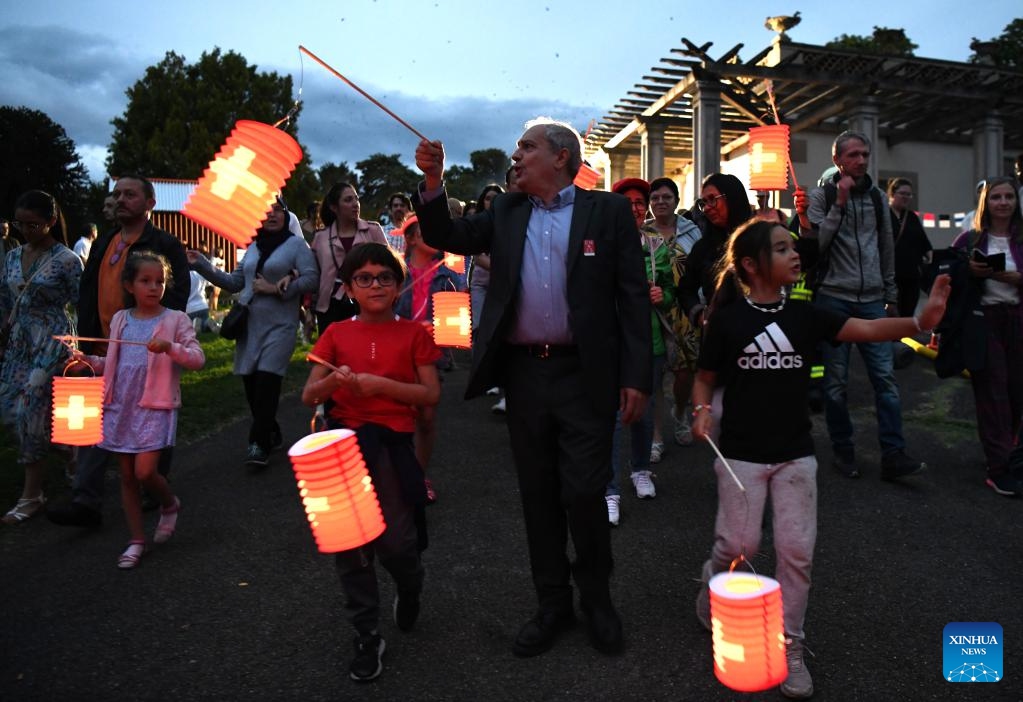 People parade with lanterns during an event in commemoration of the Swiss National Day at La Grange Park in Geneva, Switzerland, Aug. 1, 2023.(Photo: Xinhua)