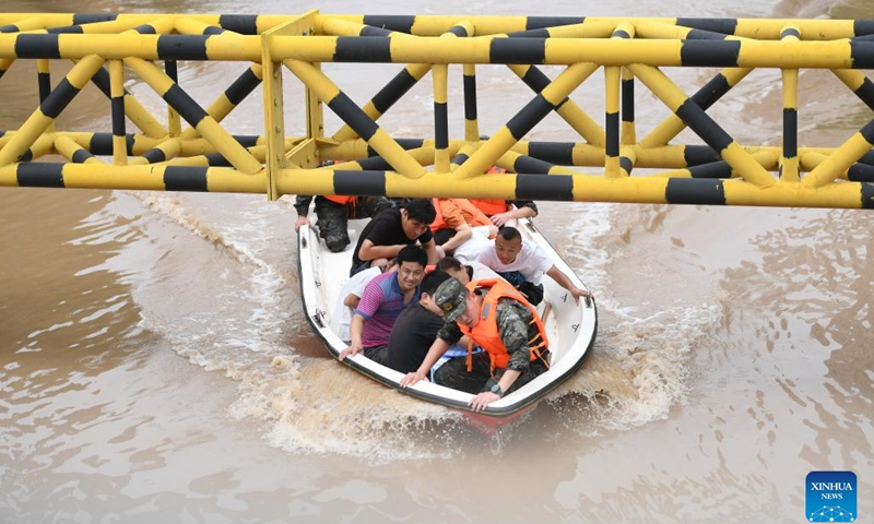 Rescuers transfer flood-trapped people in Zhuozhou, north China's Hebei Province, Aug. 2, 2023. Nine people have died and six are missing in north China's Hebei Province as of noon on Tuesday as rainstorms continue, local authorities have said. Statistics show that rainstorms had impacted a total of 540,703 people in 87 counties and districts in Hebei by noon on Tuesday.(Photo: Xinhua)