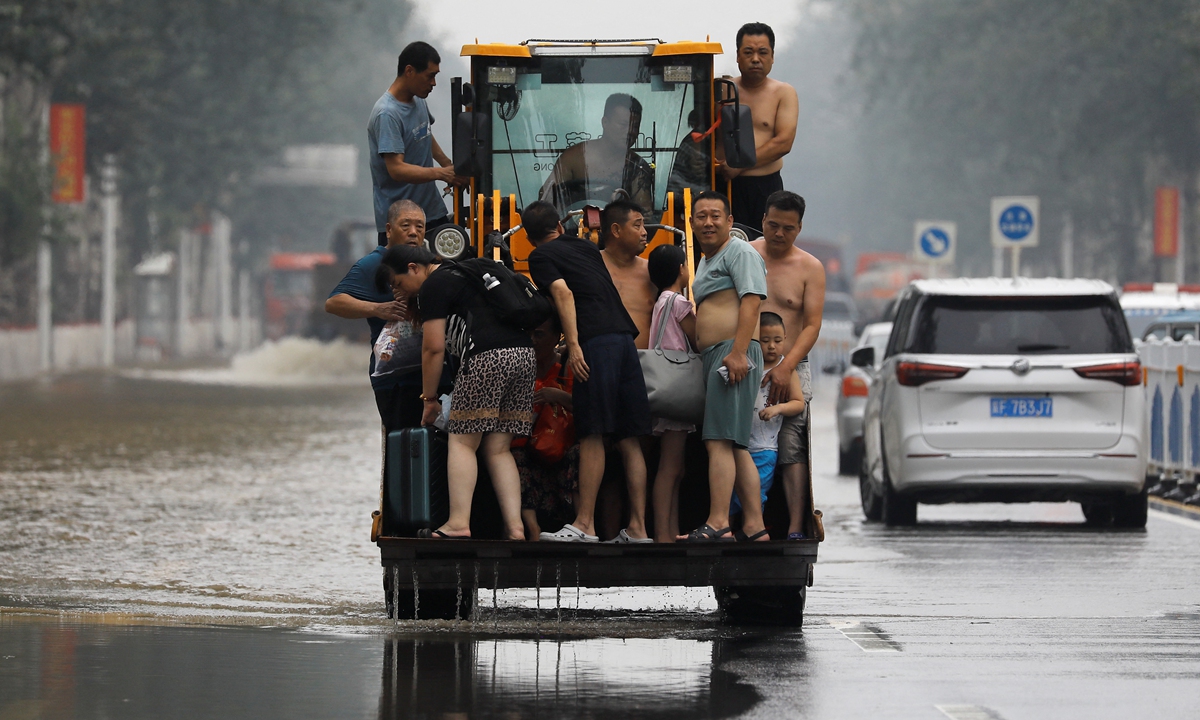 Residents of Zhuozhou, North China's Hebei Province, take refuge from floods on a tractor on August 3, 2023. Torrential rains have battered Hebei Province, especially Zhuozhou for days. Hebei Province relocated over 1.2 million people as of 10 am Thursday, said local authorities. Photo: IC