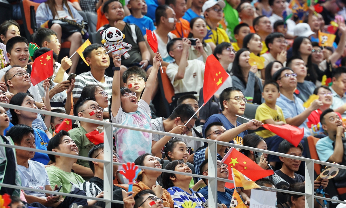 Fans react during the women's basketball match at the Fenghuangshan Sports Park Gymnasium in Chengdu on Thursday.  Photo: Cui Meng/Global Times