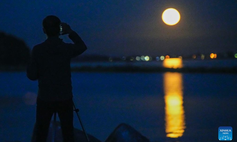 A man watches a supermoon in Vancouver, Canada, on Aug. 1, 2023.(Photo: Xinhua)