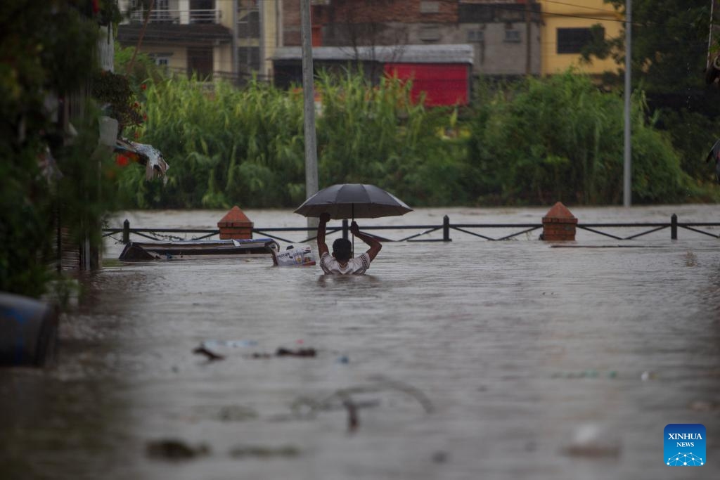 A man wades through flood water in Kathmandu, Nepal on Aug. 8, 2023. Monsoon rains have caused floods in various parts of Kathmandu.(Photo: Xinhua)