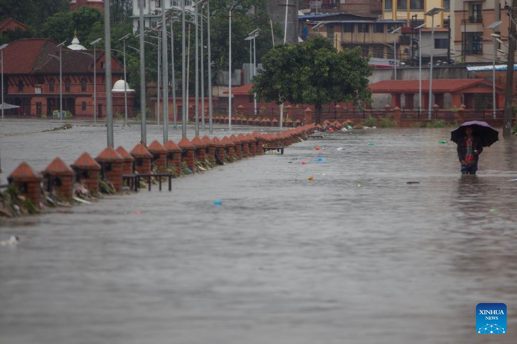 A man wades through flood water in Kathmandu, Nepal on Aug. 8, 2023. Monsoon rains have caused floods in various parts of Kathmandu.(Photo: Xinhua)