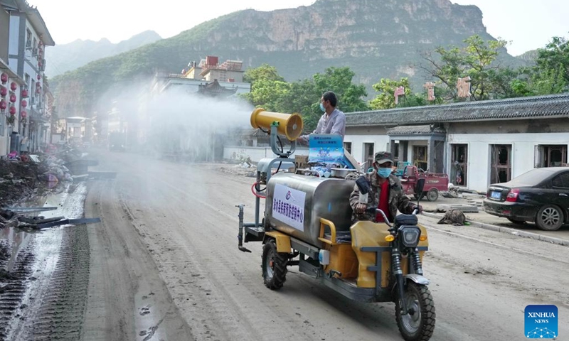 Volunteers conduct disinfection in Xiazhuang Village, Sanpo Town, Laishui County, in north China's Hebei Province, Aug. 8, 2023. Affected by Typhoon Doksuri, Laishui County suffered heavy rainfall recently and some villages encountered traffic and communication disruptions. At present, the local authorities are mending infrastructure damaged by flood to bring life back to normal as soon as possible.(Photo: Xinhua)