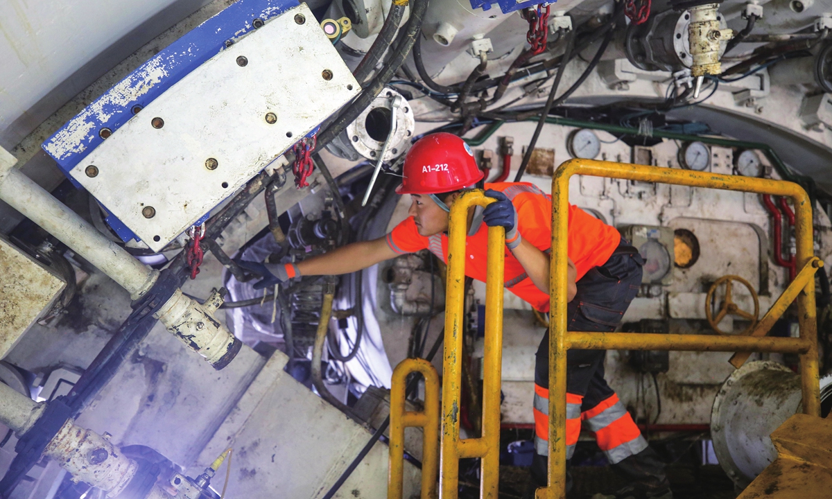 A worker conducts maintenance on the new 