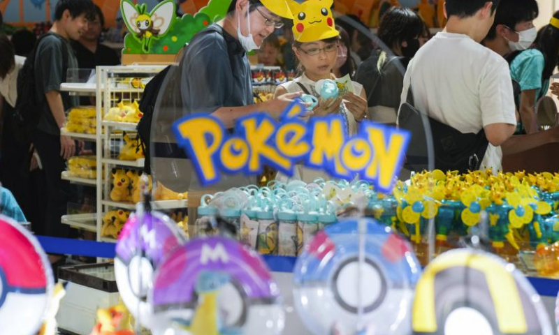 People select goods at a Pokemon store of Minatomirai in Yokohama, Japan, Aug. 13, 2023. To commemorate the launch of the 2023 Pokemon World Championships, a Pokemon festival is held in Yokohama's Minatomirai from Aug.11 to Aug.14. (Xinhua/Zhang Xiaoyu)