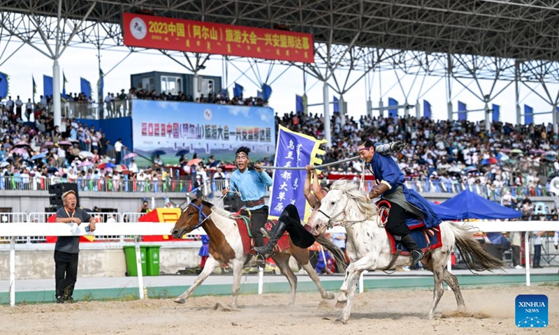 Performers stunt at the opening ceremony of a Nadam fair in Horqin Right Wing Front Banner, Hinggan League, north China's Inner Mongolia Autonomous Region, Aug. 9, 2023. A Nadam fair kicked off here on Wednesday and will last till Aug. 12. A variety of activities as horse racing, wrestling competition, archery contest and music festival will be held during the event.(Photo: Xinhua)