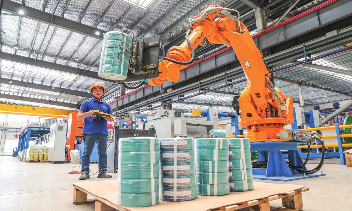 A staff member is busy producing cables on August 10, 2023 in Huzhou, East China’s Zhejiang Province. The enterprise has digitalized the production process and enhanced the core competitiveness of products by adapting emerging technologies such as 5G and big data. Photo: cnsphoto