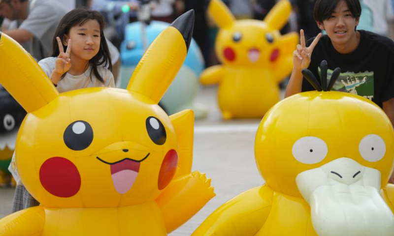 People take photos with inflatable Pokemon characters at Minatomirai in Yokohama, Japan, Aug. 13, 2023. To commemorate the launch of the 2023 Pokemon World Championships, a Pokemon festival is held in Yokohama's Minatomirai from Aug.11 to Aug.14. (Xinhua/Zhang Xiaoyu)