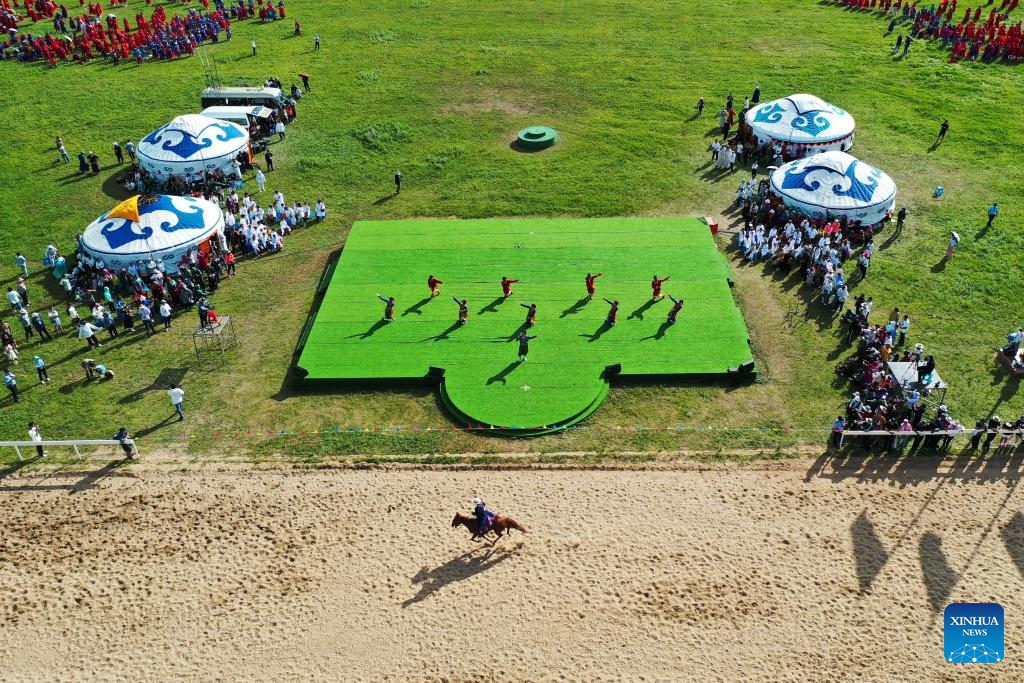 This aerial photo taken on Aug. 9, 2023 shows the opening ceremony of a Nadam fair in Horqin Right Wing Front Banner, Hinggan League, north China's Inner Mongolia Autonomous Region. A Nadam fair kicked off here on Wednesday and will last till Aug. 12. A variety of activities as horse racing, wrestling competition, archery contest and music festival will be held during the event.(Photo: Xinhua)