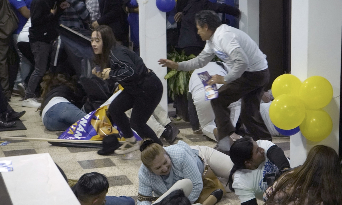 People take cover after shots were fired at the end of a rally for Ecuadorian presidential candidate Fernando Villavicencio in Quito, on August 9, 2023 local time, which killed Villavicencio. China condemned the attack and sent condolences on the tragic assassination. Photo: AFP