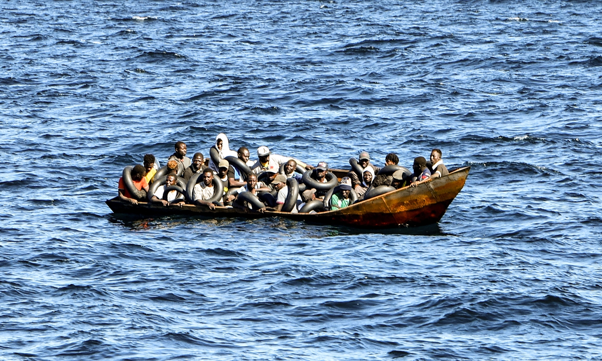 Migrants of African origin trying to flee to Europe are crammed on board a small boat, as Tunisian coast guards prepare to transfer them onto their vessel, at sea between Tunisia and Italy, on August 10, 2023. Mediterranean Sea crossing attempts from Tunisia have multiplied following an incendiary speech by Tunisian President Kais Saied who alleged that hordes of irregular migrants were causing crime and posing a demographic threat to the mainly Arab country.Photo:AFP