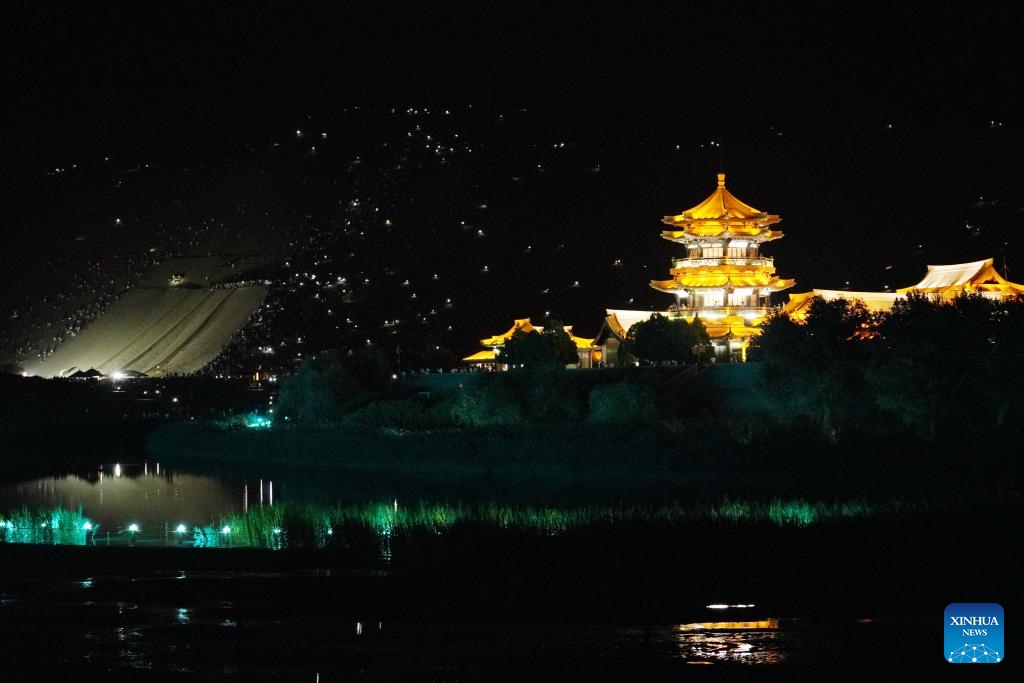 Tourists attend a live concert with their mobile phone flashlights turned on at the Mingsha Mountain and Crescent Spring scenic spot in Dunhuang, northwest China's Gansu Province, Aug. 8, 2023. The Mingsha Mountain and Crescent Spring scenic spot in Dunhuang has entered its peak tourist season during the summer vacation.(Photo: Xinhua)