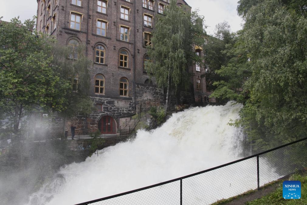 This photo taken on Aug. 10, 2023 shows water flooding down the Aker River in the downtown area of Oslo, capital of Norway. Storm Hans has been battering Norway since Monday, resulting in over 4,000 reports of damages to properties.(Photo: Xinhua)