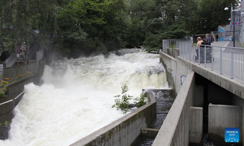 This photo taken on Aug. 10, 2023 shows water flooding down the Aker River in the downtown area of Oslo, the capital of Norway. Storm Hans has been battering Norway since Monday, resulting in over 4,000 reports of damages to properties.(Photo: Xinhua)